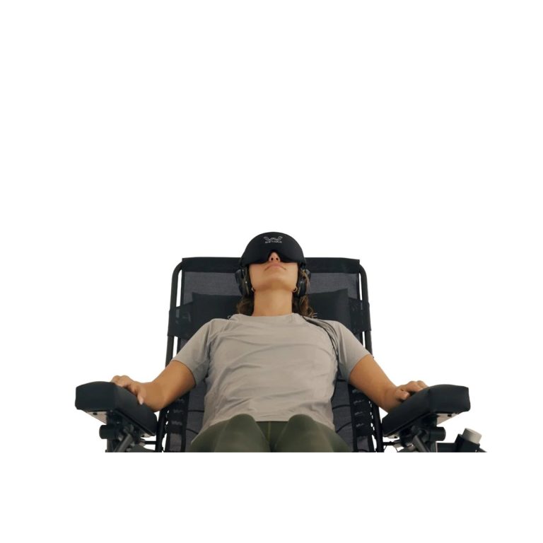 Person resting in a reclining chair wearing a headset