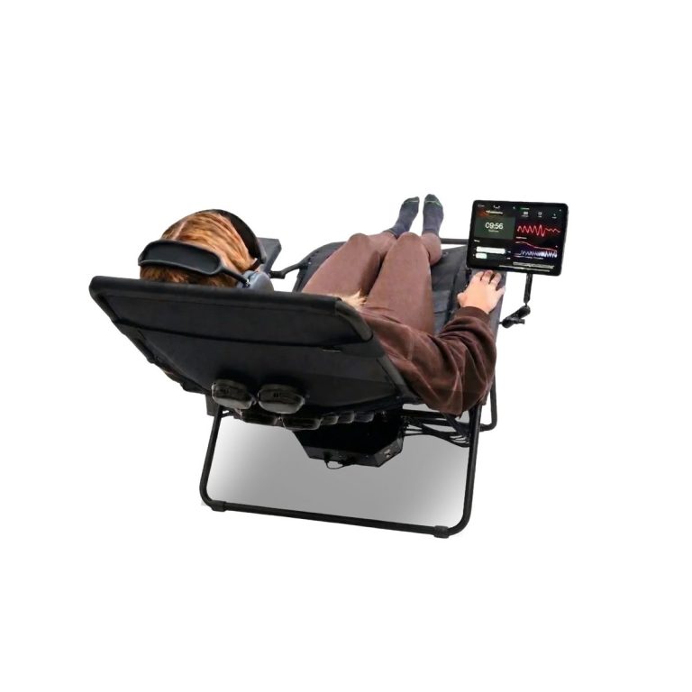 Person reclining in a zero-gravity chair with a headset and tablet